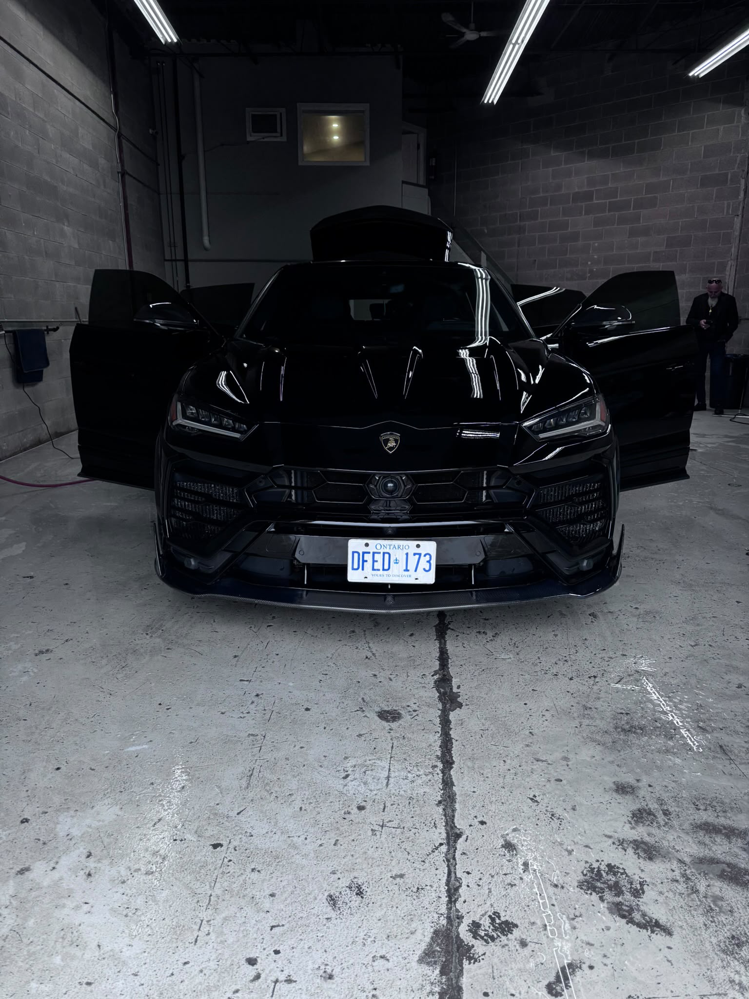 Lamborghini Urus — Head-On Showroom Bay Headlights Glowing